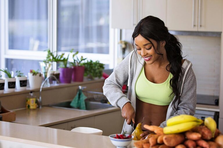 A woman in the kitchen preparing healthy food