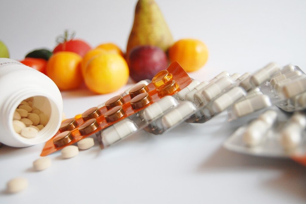 Vitamin Pills and Fruits on a table